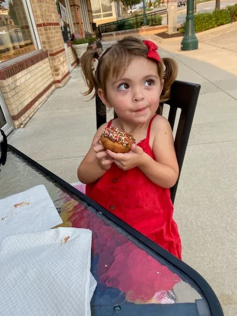 Girl eating Donut.webp